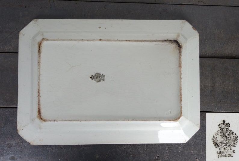 May include: White rectangular ceramic serving platter with a slightly raised rim and a beveled edge. The platter has a black stamp on the bottom that reads "GRANDE LUNEVILLES FRANCE".