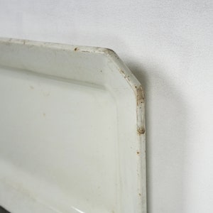 May include: White rectangular serving tray with a slightly raised edge. The tray has a slightly worn, vintage look.