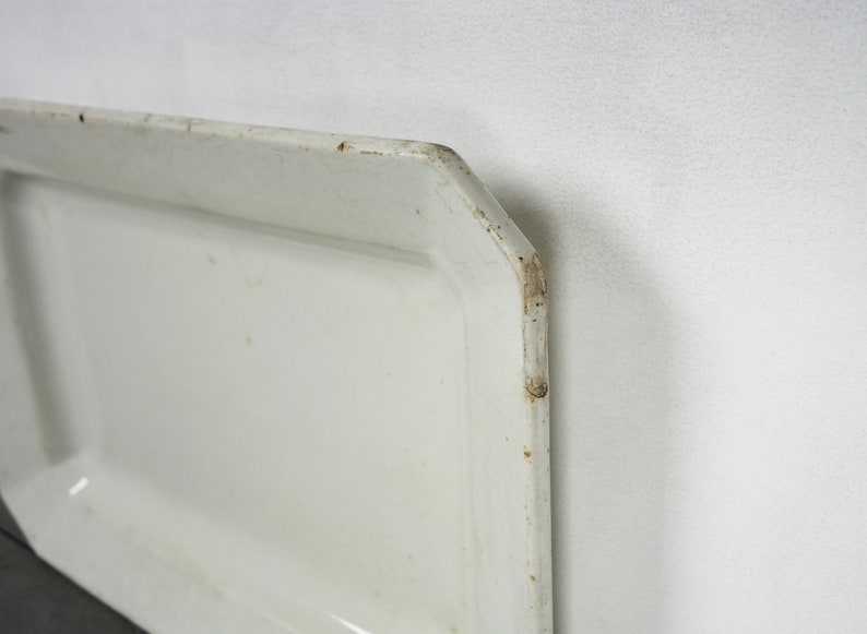 May include: White rectangular serving tray with a slightly raised edge. The tray has a slightly worn, vintage look.