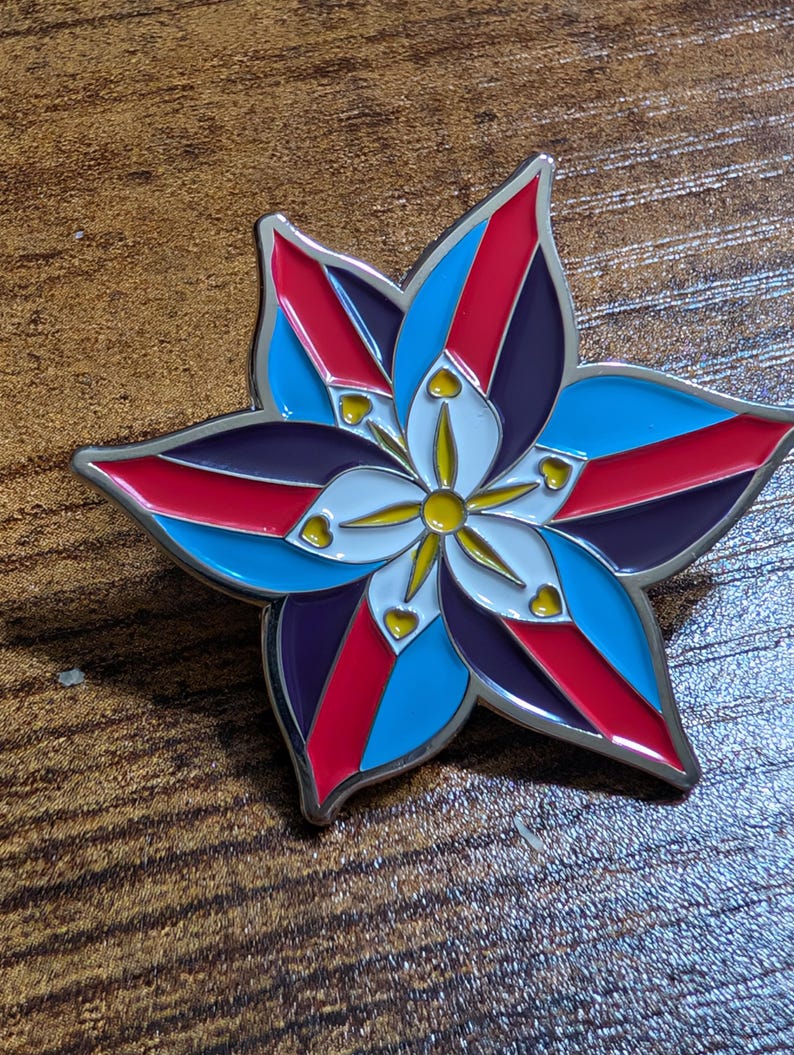 May include: A silver metal pin shaped like a flower with red, blue, white, and yellow enamel. The flower has five petals and a yellow center.
