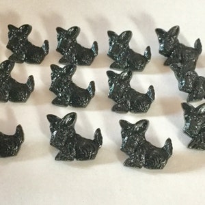 May include: A set of 12 black plastic buttons shaped like Scottish Terriers. The buttons are about 1 inch in size and have a shiny finish.