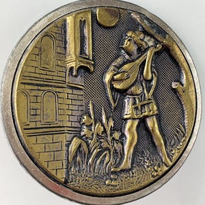 May include: A round, antique-style button with a detailed relief design. The central image depicts a figure playing a lute near a building. The color palette includes gold, silver, and bronze tones, creating a vintage aesthetic.