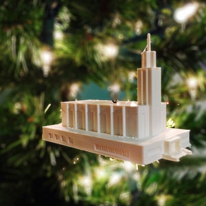 May include: White 3D printed model of a church building, a Christmas ornament.