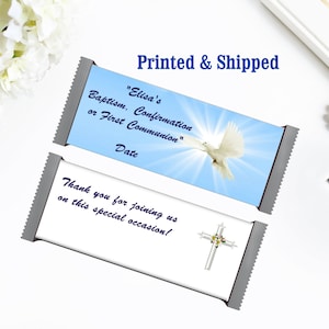 May include: Two white chocolate bar wrappers with blue and white designs. The top wrapper has a white dove flying in a blue sky with the text "Elisa's Baptism, Confirmation or First Communion" and "Date". The bottom wrapper has a silver cross with a floral design and the text "Thank you for joining us on this special occasion!"