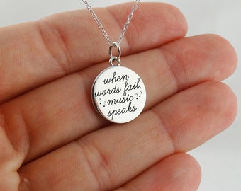 May include: Silver necklace with a round pendant that says "when words fail, music speaks" with musical notes.