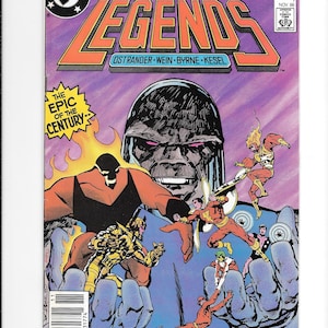 May include: A comic book titled Legends issue 1, dated November 1986, featuring a large dark-skinned figure in the background with several smaller costumed characters in the foreground, including a red-clad figure and a gold-armored character.