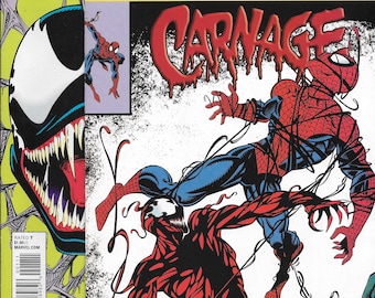 May include: Two Marvel True Believers comic books featuring Venom and Carnage. The front comic shows Carnage in red and black attacking Spider-Man, who is wrapped in black webbing. The background comic displays a large Venom face with sharp teeth.