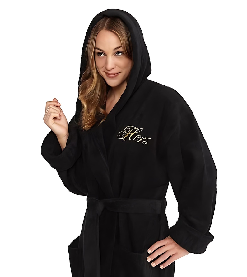 May include: Black hooded robe with a gold embroidered "Hers" on the chest.