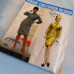 May include: Vogue Couturier Design pattern 1481 by Fabiani of Italy. The pattern features two women wearing matching skirt suits. One woman is wearing a blue suit and the other is wearing a yellow suit.