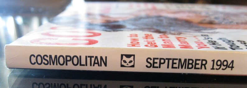 May include: A white magazine with the title "COSMOPOLITAN" and the date "SEPTEMBER 1994" printed on the cover. A small cat icon is also visible on the cover.