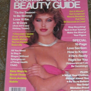 May include: A pink magazine cover with the title "Cosmopolitan's Beauty Guide" and a woman with long blonde hair wearing a pink strapless top. The cover features articles about losing weight, skincare, and relationships.