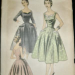 May include: Vintage sewing pattern titled "Advance 7013" with illustrations of three dresses. The dresses are in shades of grey, green with white polka dots, and pink. The pattern is for a size 18, with a bust size of 91 cm.