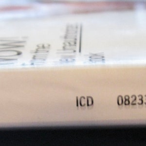 May include: Close-up of the spine of a magazine with a blue and white logo, the text "WOW!" and the text "VOL. 217, NO. 3". The magazine also has the text "ICD 08233" printed on the spine.