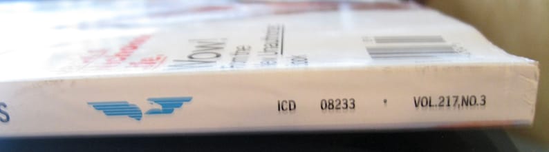 May include: Close-up of the spine of a magazine with a blue and white logo, the text "WOW!" and the text "VOL. 217, NO. 3". The magazine also has the text "ICD 08233" printed on the spine.
