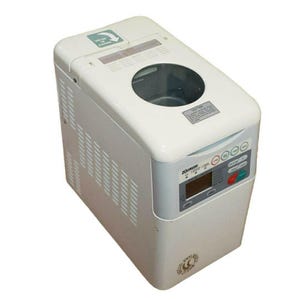 May include: A white Zojirushi bread maker with a digital display and control panel. The appliance has a clear viewing window on top and a series of buttons for various settings. The bread maker is designed for home use.