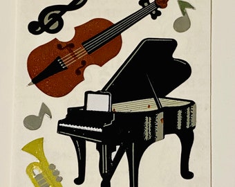 May include: A black grand piano with a white keyboard and a brown cello with a black bow. There are also three silver musical notes and a gold trumpet.