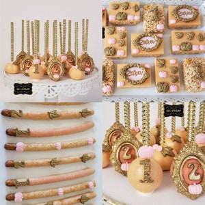 May include: A set of fall-themed cake pops, pretzel rods, and rice crispy treats decorated with gold, pink, and brown accents. The treats feature a pumpkin design and the numbers "1" and "2".