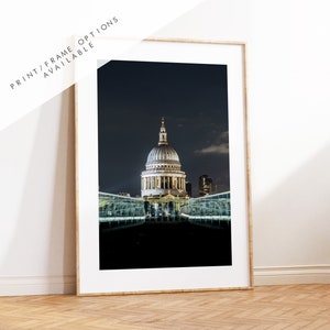 May include: A nighttime photograph of St. Paul's Cathedral in London, England. The cathedral is illuminated and stands out against the dark sky. A glass walkway is in the foreground.
