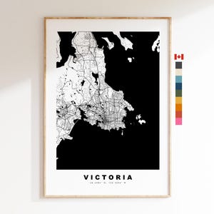 May include: Black and white map print of Victoria, Canada. The map shows the city's streets and coastline. The city name is printed at the bottom of the map.