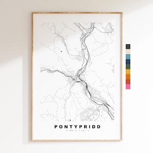 May include: A framed black and white map print of Pontypridd, showing roads, rivers, and topographical details. The town's name is printed in bold, capital letters at the bottom. Coordinates are also included.