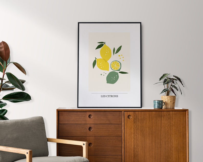 May include: A black framed print with a minimalist illustration of lemons and limes on a cream background. The text "LES CITRONS" is printed at the bottom of the print.