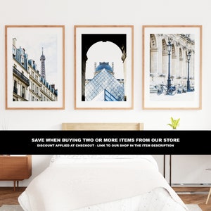 May include: Three framed photographs of Parisian architecture. The first photo shows a street lined with buildings and a tall tower in the distance. The second photo shows a view of the Louvre Pyramid through an archway. The third photo shows a row of columns with a bicycle parked in front.