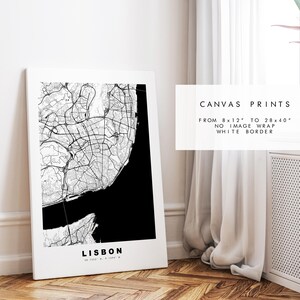 May include: Black and white map print of Lisbon, Portugal. The map is framed and hanging on a white wall. The text "CANVAS PRINTS" is visible in the image. The text "FROM 8 x 12" TO 28 x 40" NO IMAGE WRAP WHITE BORDER" is also visible in the image.