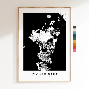 May include: A framed black and white map print of North Uist, with the island's outline in white against a black background. The text "NORTH UIST" is centered at the bottom, with coordinates below. The frame is a light wood color.