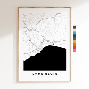 May include: Black and white map print of Lyme Regis, a coastal town in Dorset, England. The map shows the town's streets and coastline. The text "LYME REGIS" and the coordinates "50.7333° N, 2.9344° W" are printed below the map.