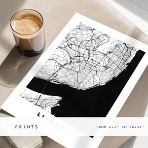 May include: A black and white map print of Lisbon, Portugal. The map shows the city's streets and waterways. The print is available in sizes from 6x4 inches to 30x40 inches.