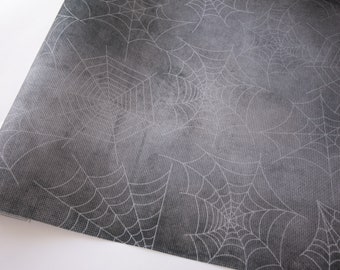 May include: Gray wrapping paper with a white spiderweb pattern.
