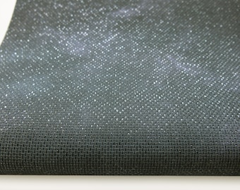 May include: Close-up of a dark gray fabric with a subtle shimmer. The fabric has a woven texture with a fine, even pattern.