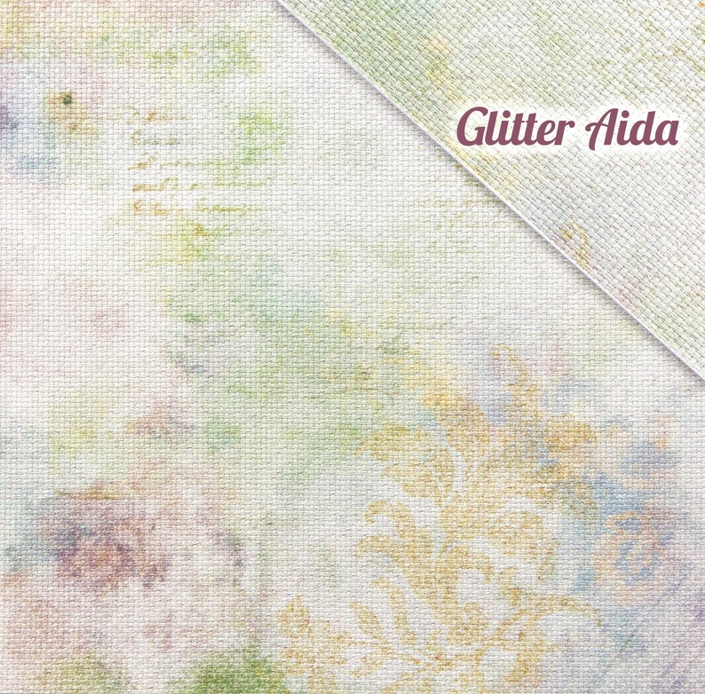 Vintage Glitter Aida Cloth, Opalescent Cross Stitch Fabric, Printed, 14 / 16 / 18 / 20 Count A close-up of a white fabric with a subtle green and brown pattern. The fabric has a textured surface and is labeled "Glitter Aida".