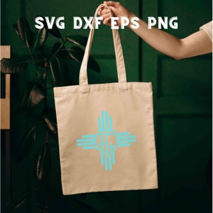 May include: A white tote bag with a turquoise blue symbol of four hands clasped together in a cross shape. The bag is being held by a person's hand.