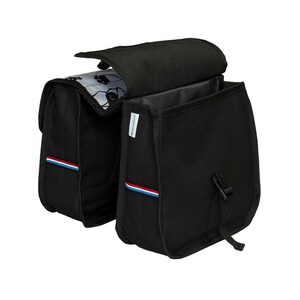 May include: A black double bicycle pannier bag featuring a white interior flap with a black paw print pattern. The bag has two main compartments with top flaps, black plastic buckle closures, and a small red, white, and blue striped fabric tag.