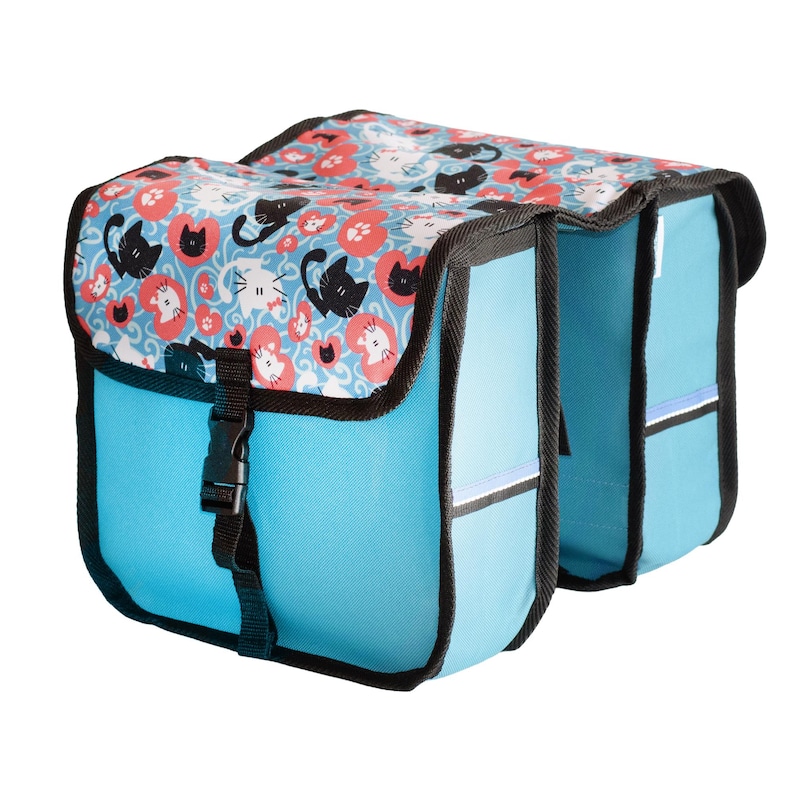 May include: A double bicycle pannier bag in bright blue with black trim and a flap featuring a repeating pattern of black and white cats, red hearts, and paw prints. The bag includes a black plastic buckle closure on the front flap.