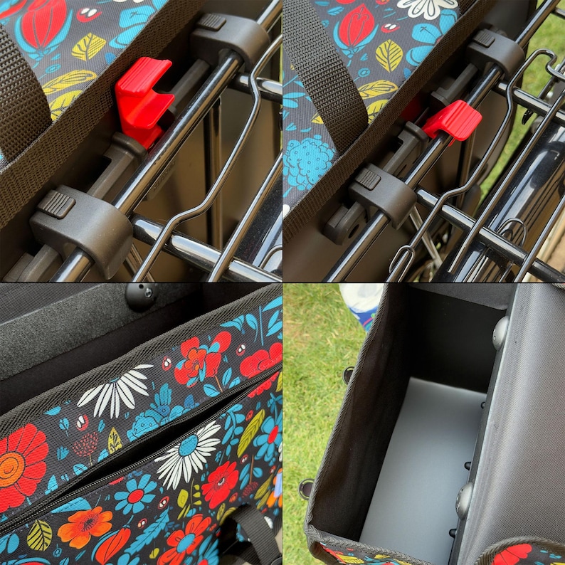 May include: Close-up of a black bicycle basket with a colourful floral pattern. The basket has a black frame and a red locking mechanism. The interior of the basket is black and has a zipped pocket.