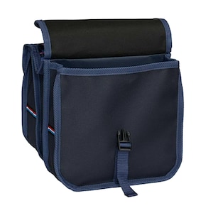 May include: A navy blue bicycle pannier bag featuring a black top flap, blue fabric trim, and a central plastic buckle closure. The side panel displays a thin horizontal stripe in red, white, and blue, with a structured design and durable fabric.