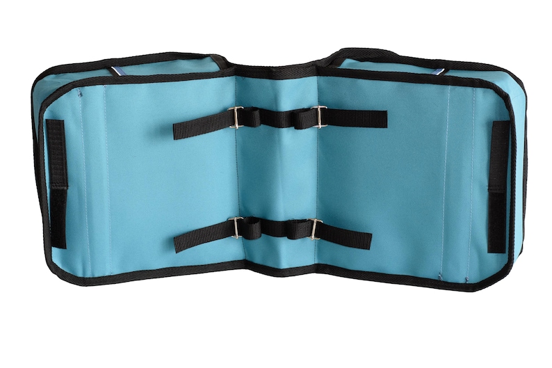 May include: A light blue double-sided saddlebag with black trim and black nylon straps featuring metal buckles. The bag has two main compartments connected by a central bridge, with black hook-and-loop fasteners on the outer edges.