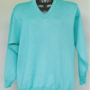 May include: A turquoise blue v-neck sweater with long sleeves.