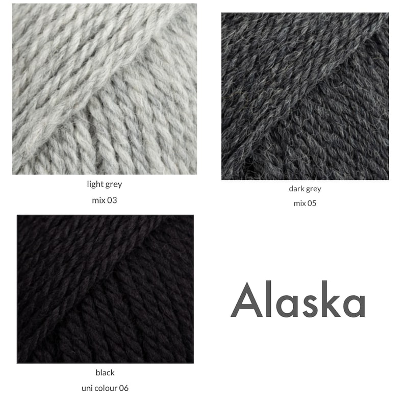 A close up of light grey, dark grey and black Alaska