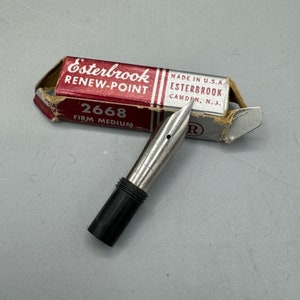May include: A silver Esterbrook Renew-Point 2668 Firm Medium fountain pen nib in its original box. The box is red and white with the brand name and model number printed on it.