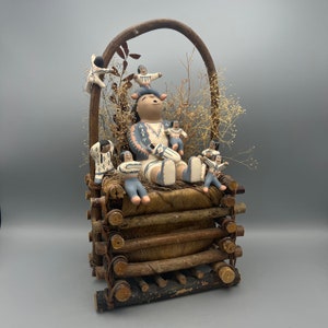 Vintage Storyteller Pottery in Basket, Not Signed