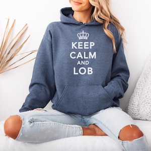 May include: A navy blue hooded sweatshirt with the text "Keep Calm and LOB" in white lettering. A crown graphic is above the text.