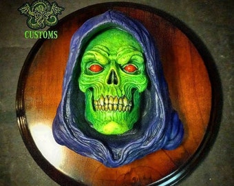 Skeletor 1/3rd  scale resin relief with eyes version  Hand painted mounted on a stained wood wall plaque