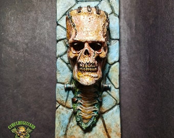 Frankenstein Skull with Spinal column and neck bolts relief ,  1/4 scale hand painted resin cast  wall plaque .