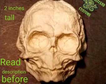 Fetal Pumpkinhead skull 1/3rd scale relief unpainted resin casting. Measures 2 inches tall