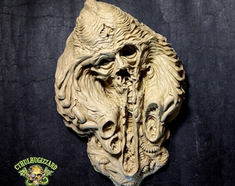 Fossil of a Pre Adamite Skull relief unpainted resin casting.