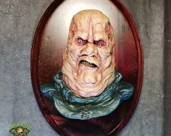 Butterball Cenobite 1/4 scale hand  painted resin relief mounted on a stained wood wall plaque.