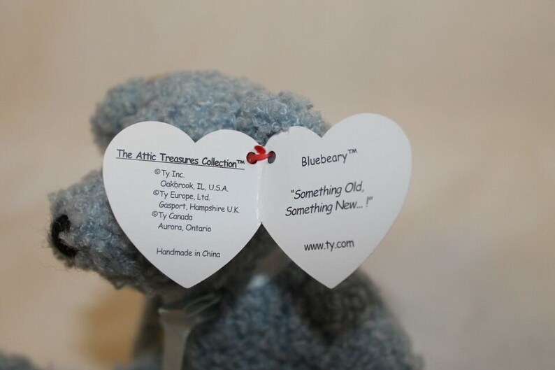 May include: Bluebeary the bear from the Attic Treasures Collection. The tag reads "Something Old, Something New..." and includes the Ty Inc. copyright information and website address.